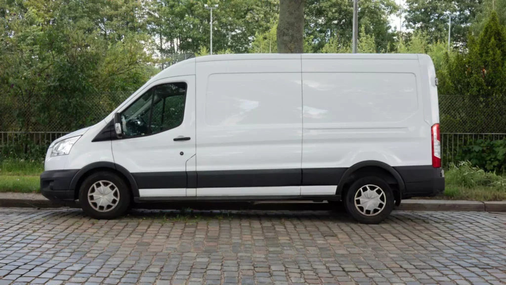 A side shot of a parked white delivery van