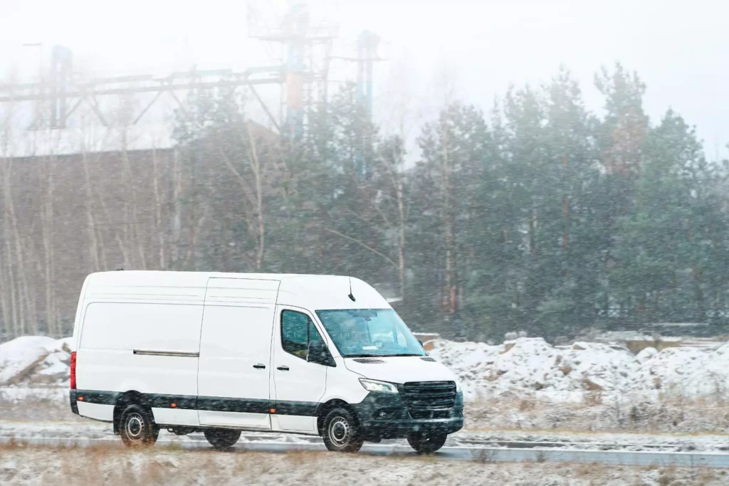 Delivery van driving in snowfall