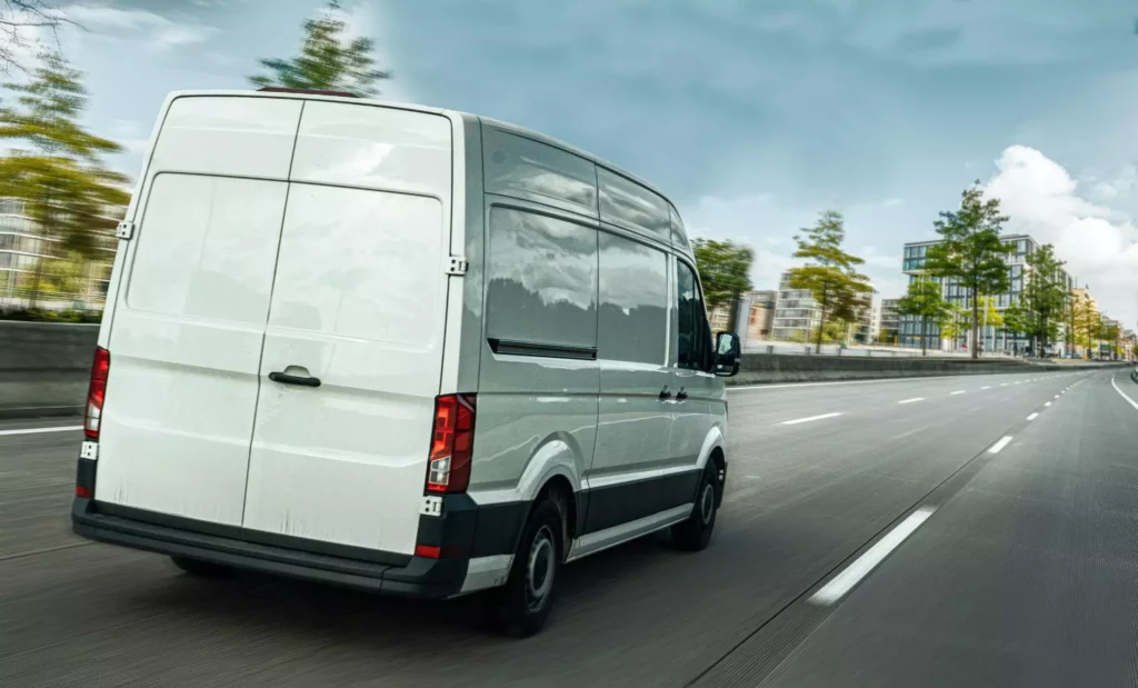 High-roof delivery van on urban expressway.