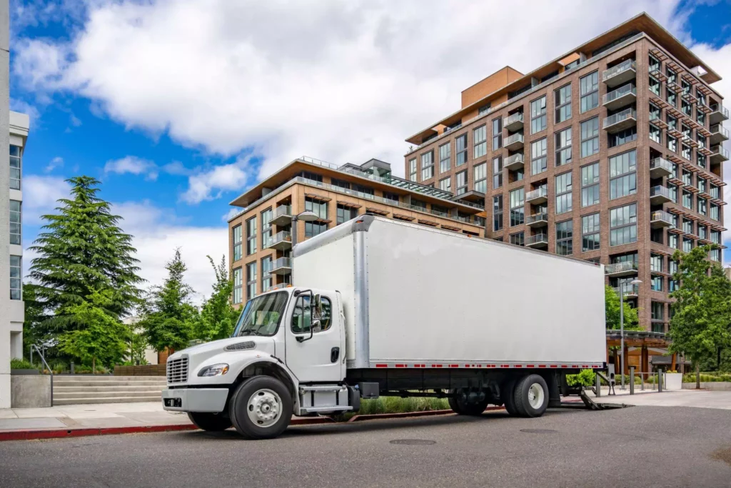 Urban box truck curbside at apartments.