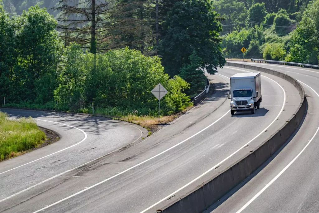 Delivery truck navigating highway ramp during last-mile route planning