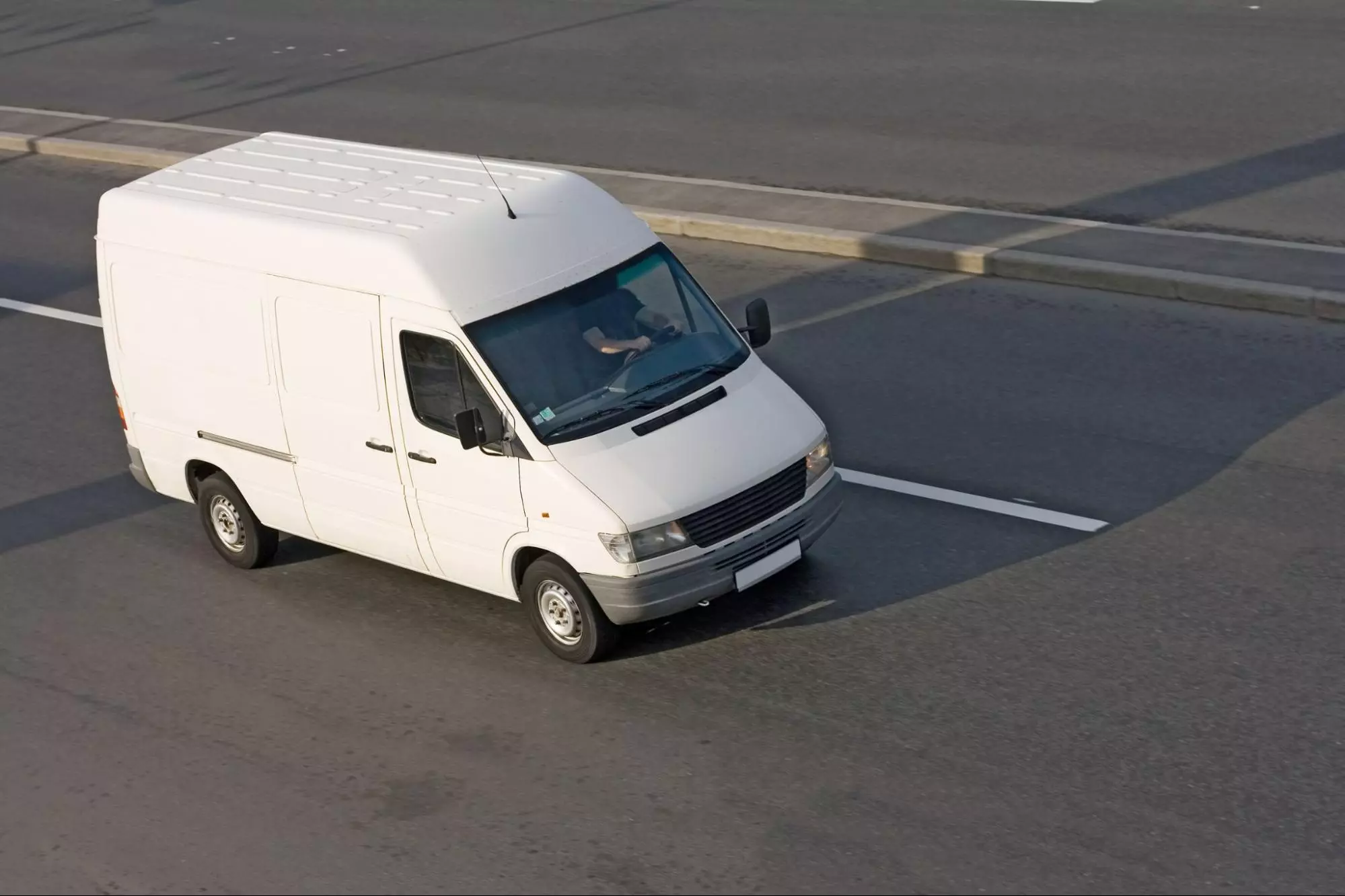 image2 A white delivery van in motion on a highway during a delivery delay