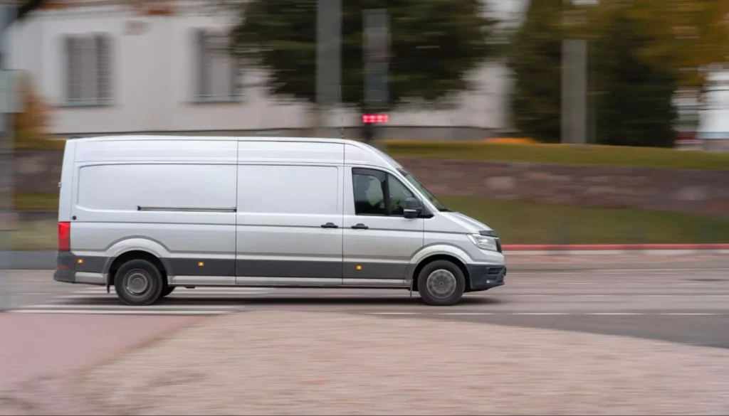 Long-wheelbase cargo van speeding through the city 