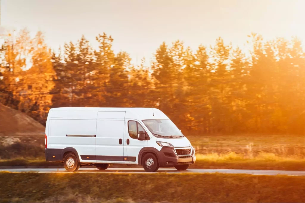 High-roof delivery van at sunset.