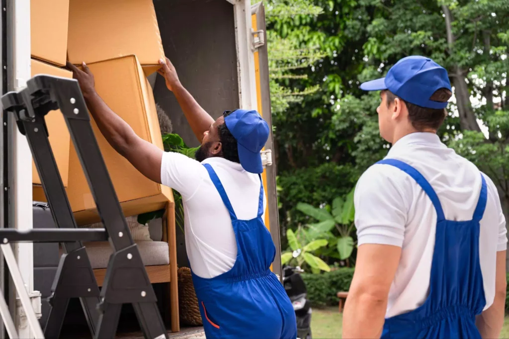 Team organizing tall stacks of boxes at the truck