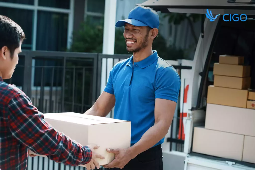 Driver giving a package to a customer, representing automated order ingestion and job creation
