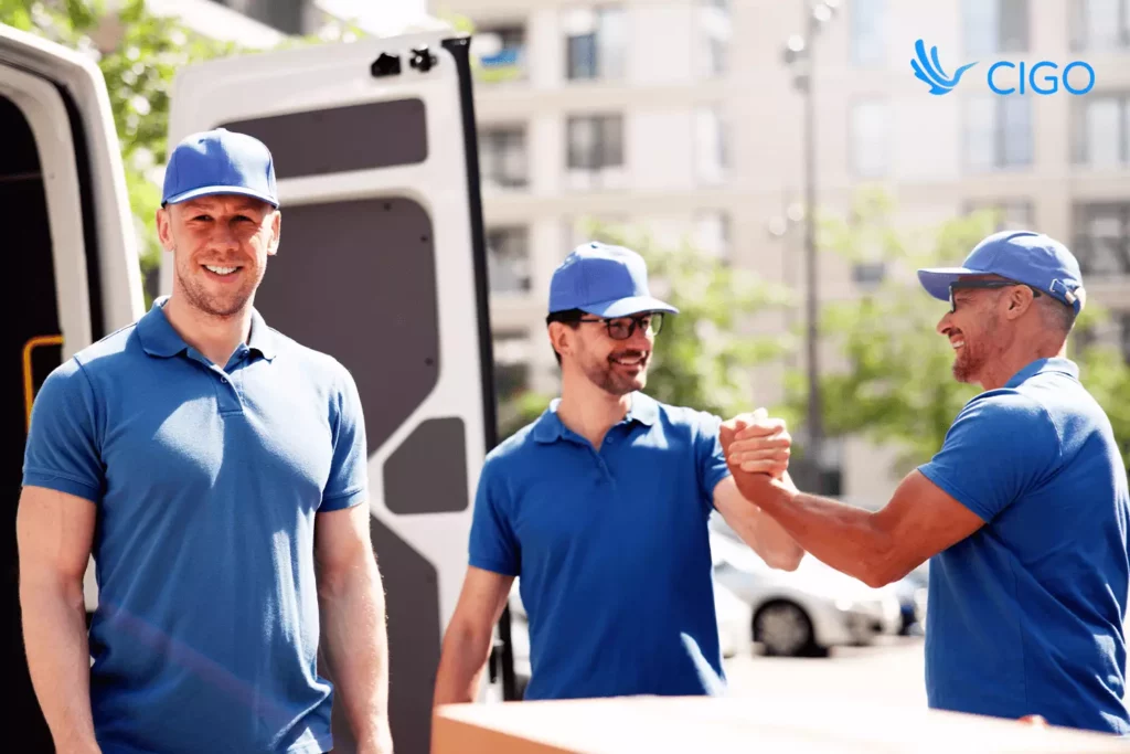 Delivery team standing by vans, celebrating strong on-time performance powered by real-time data sync