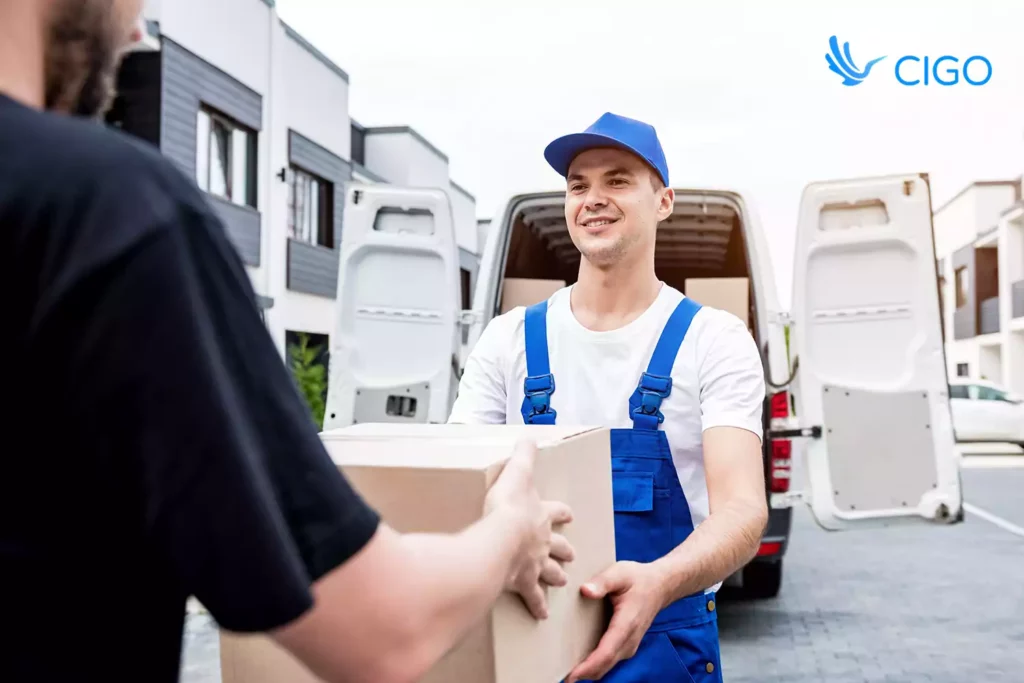 Delivery worker loading boxes into a van to show step-by-step automation in logistics operations