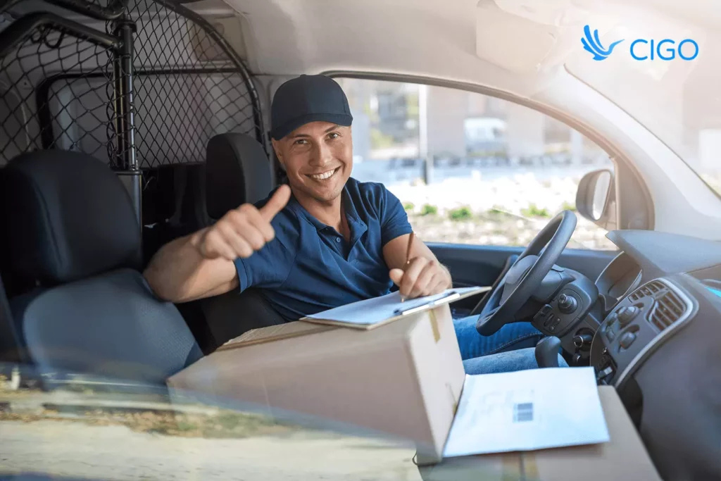Delivery driver giving thumbs up after a successful on-time stop using live delivery tracking.