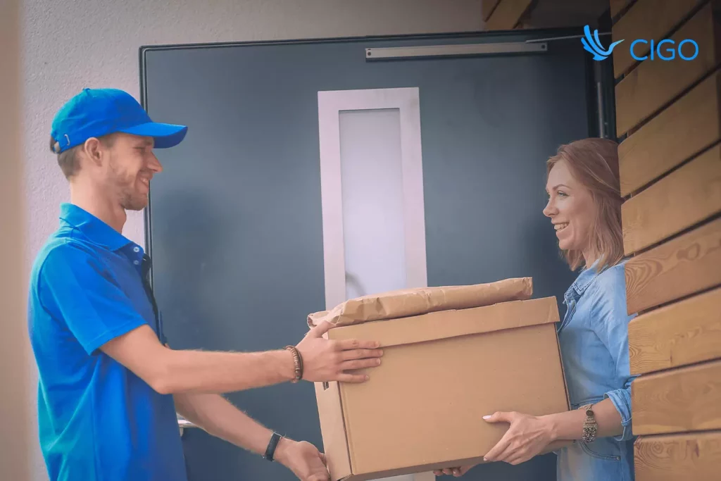 Courier handing a parcel to the customer at the doorstep