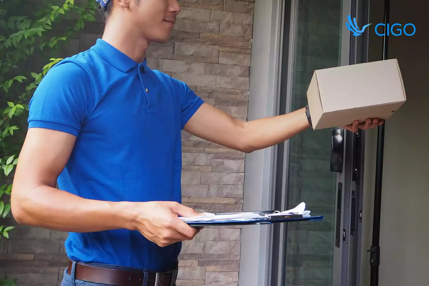 Courier handing a parcel at the door with tracked delivery