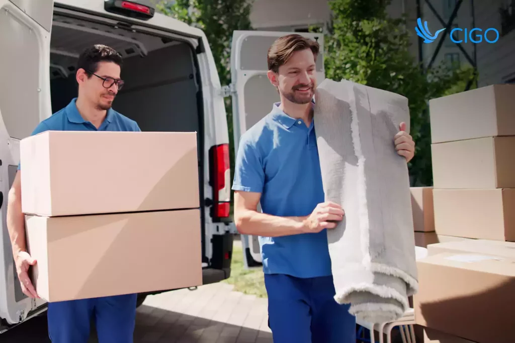 Courier loading packages into delivery van