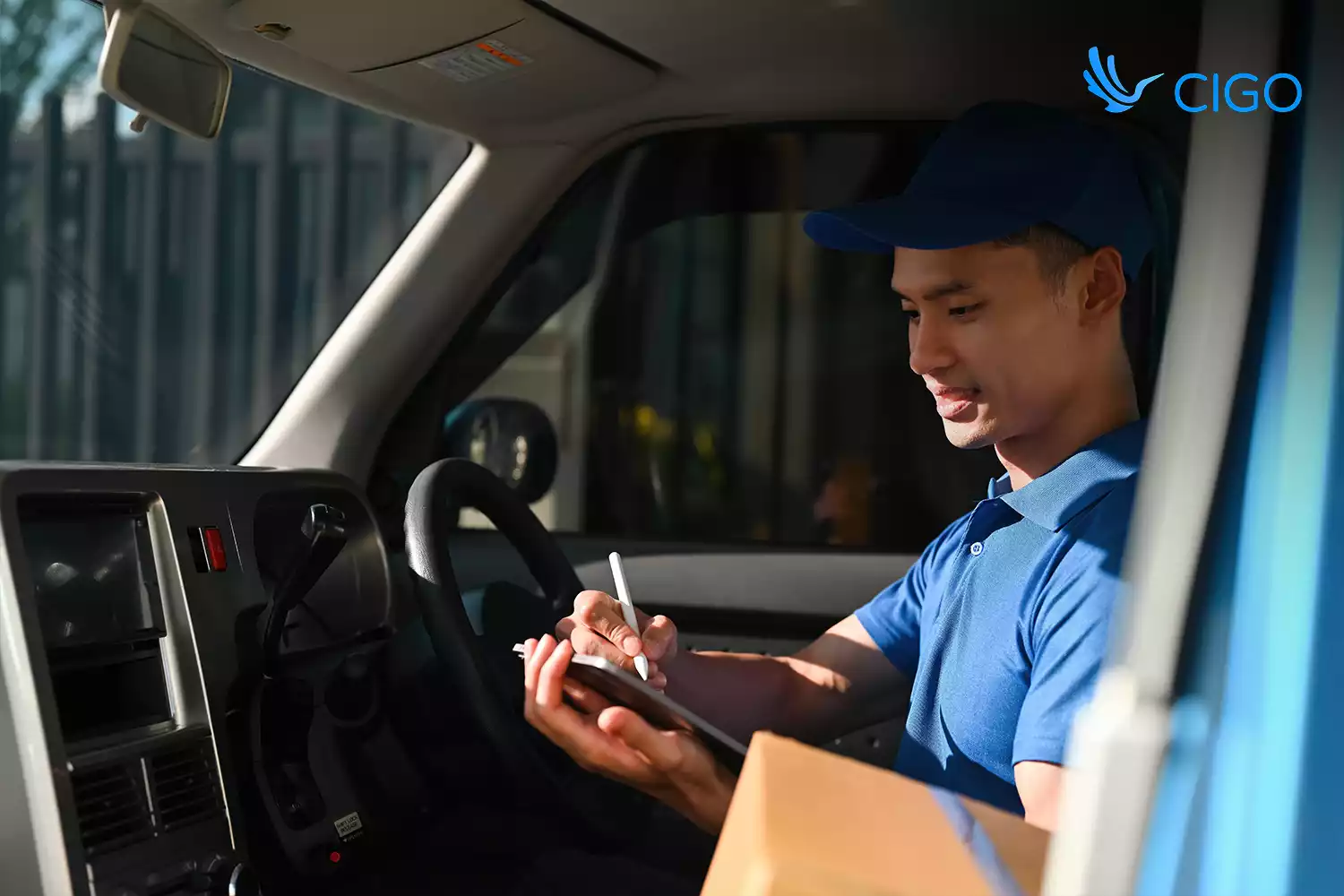 Driver updating delivery status on tablet, supporting proof of delivery and accurate ETAs
