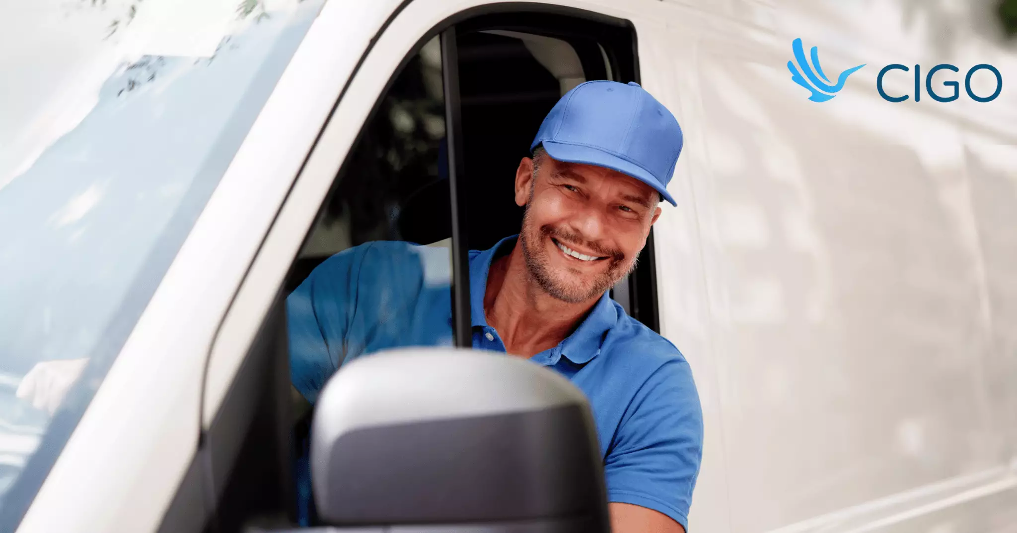 Delivery driver smiling from inside white van window