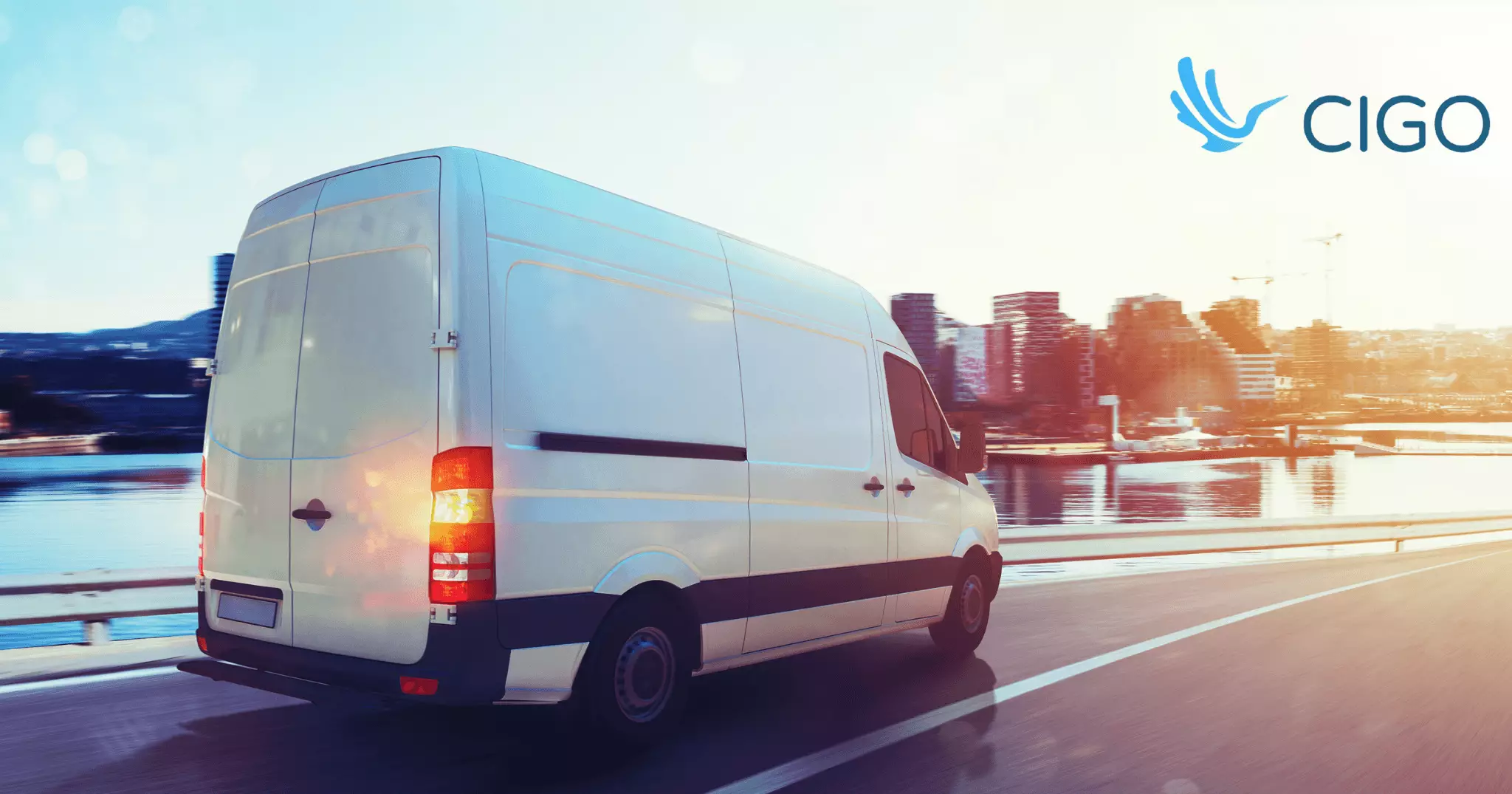 Delivery driver loading boxes into back of delivery van