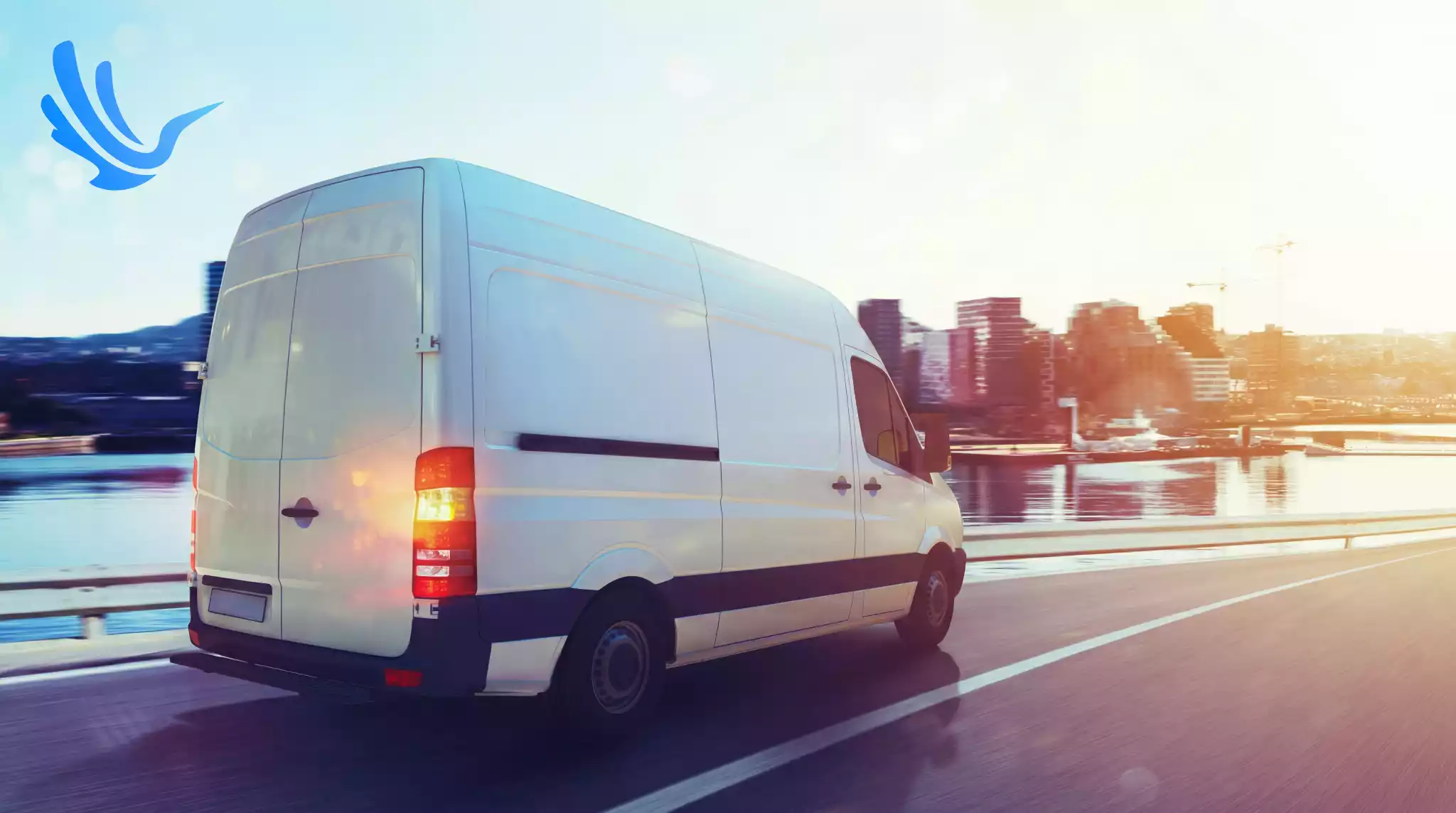 Delivery driver loading boxes into back of delivery van