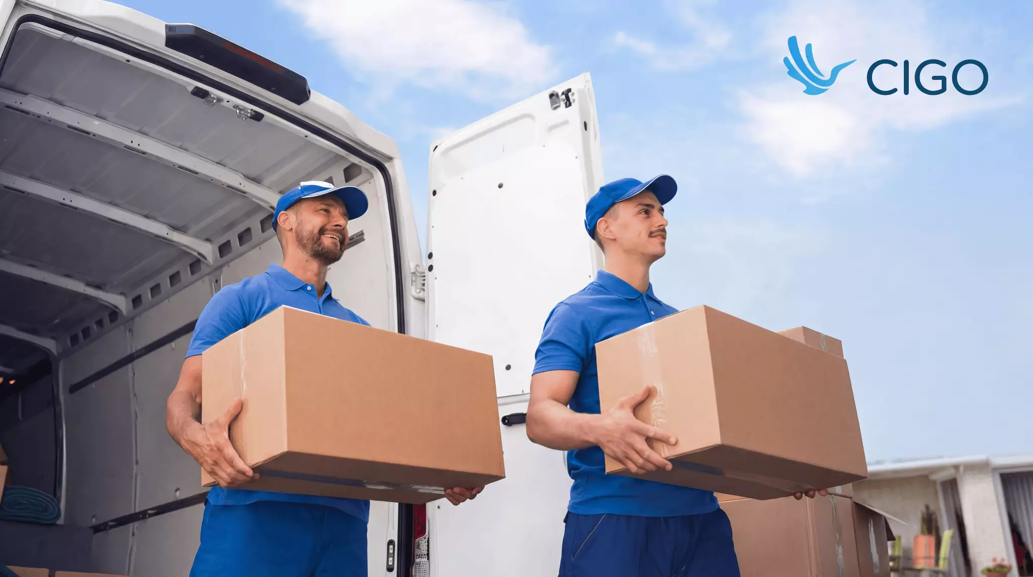 Delivery team carrying boxes from a van