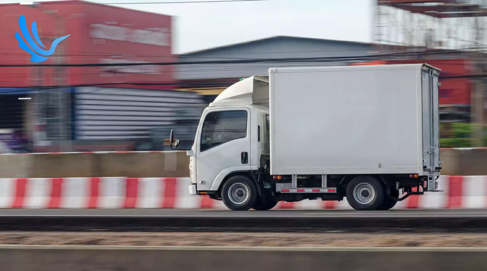White fleet delivery truck moving through last-mile zone route