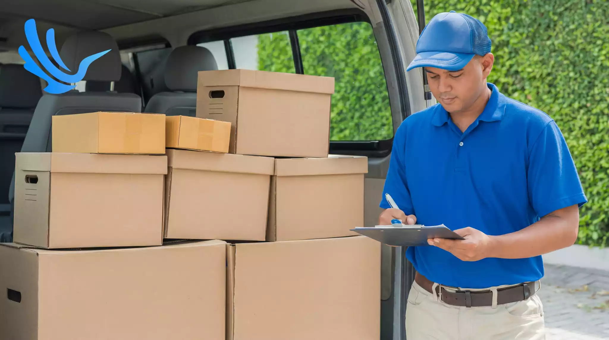 Delivery driver reviewing clipboard next to packages in van