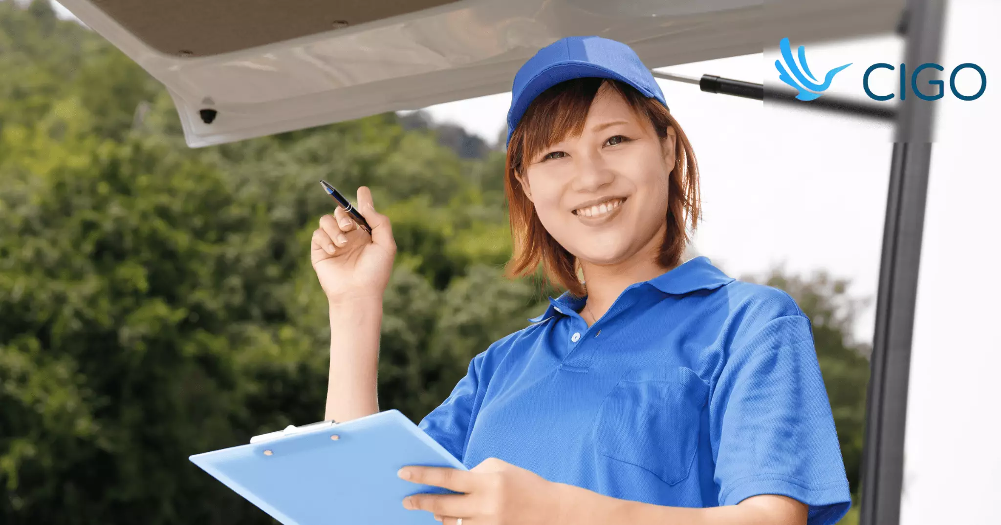 Female fleet driver reviewing capacity plan with clipboard at van
