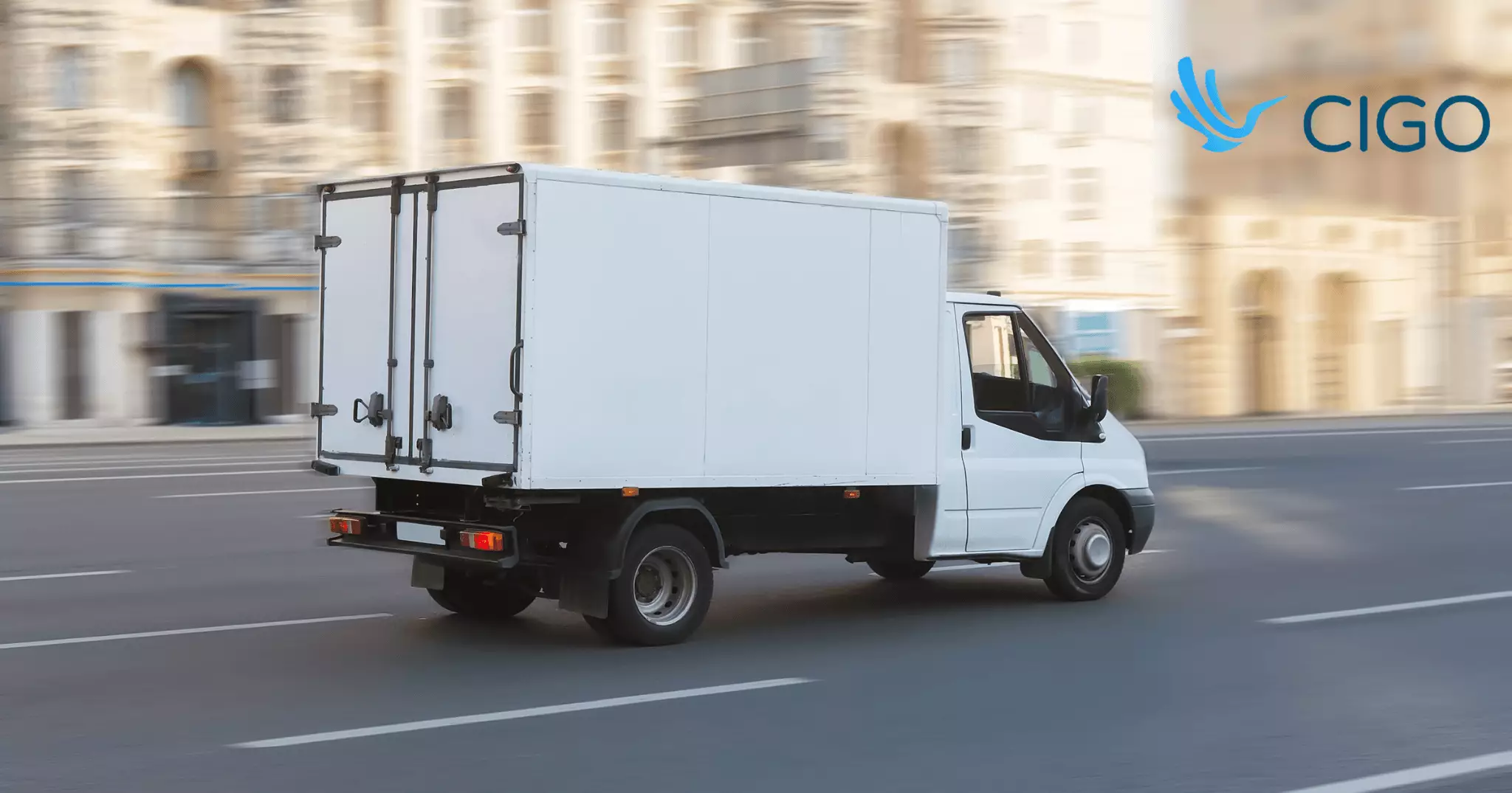 White delivery truck driving on city road with low route density