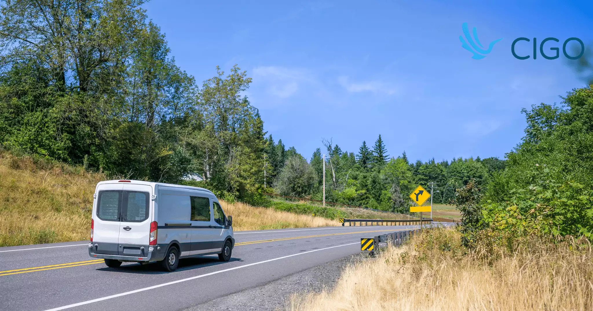 White delivery van driving on open rural highway route