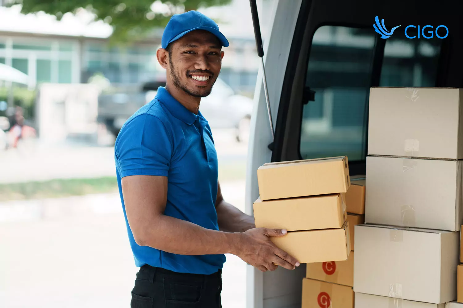 Delivery driver unloading packages from van on scheduled route