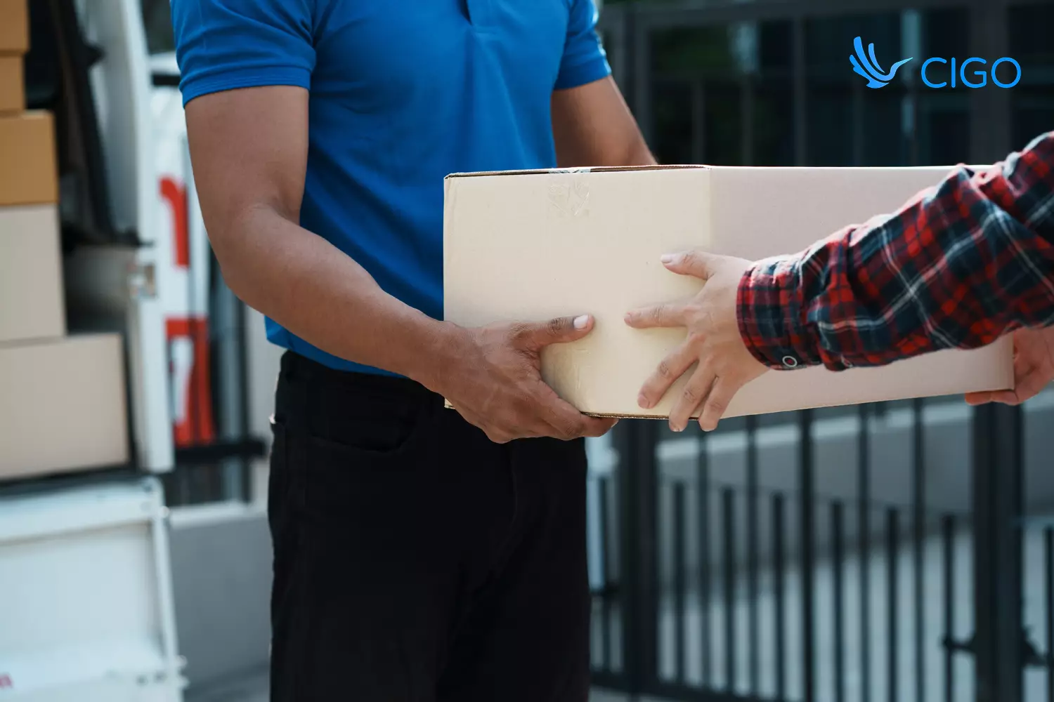 Delivery driver handing package to customer at scheduled stop