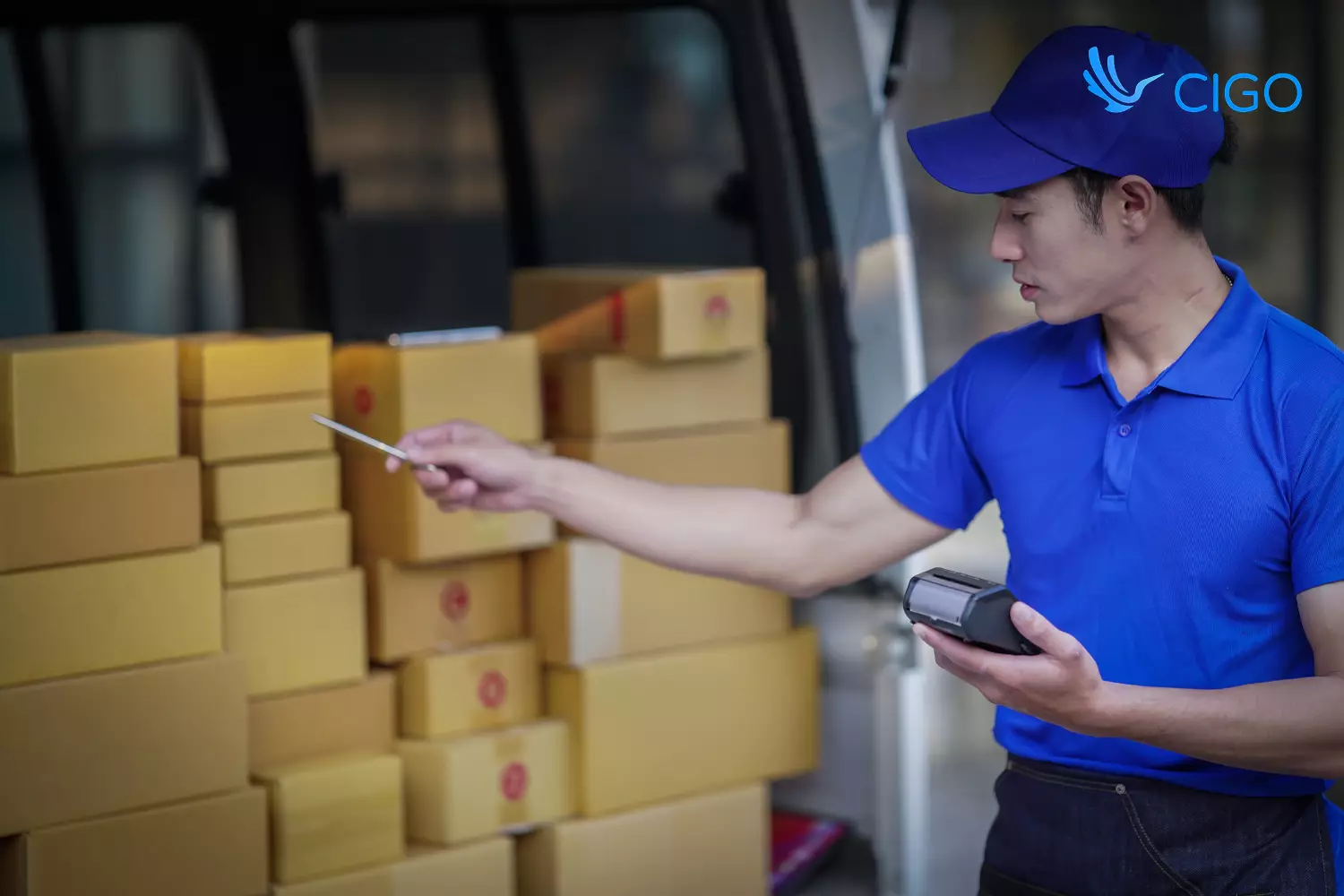 Delivery driver verifying package load count with handheld device