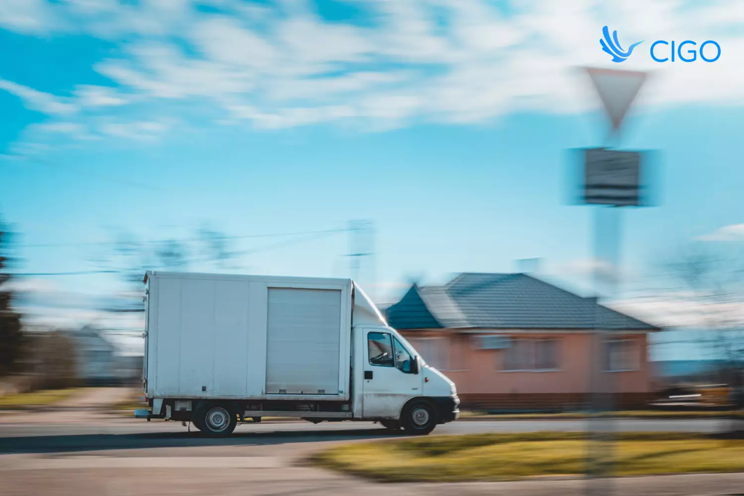 Delivery driver passing packages over gate at residential stop