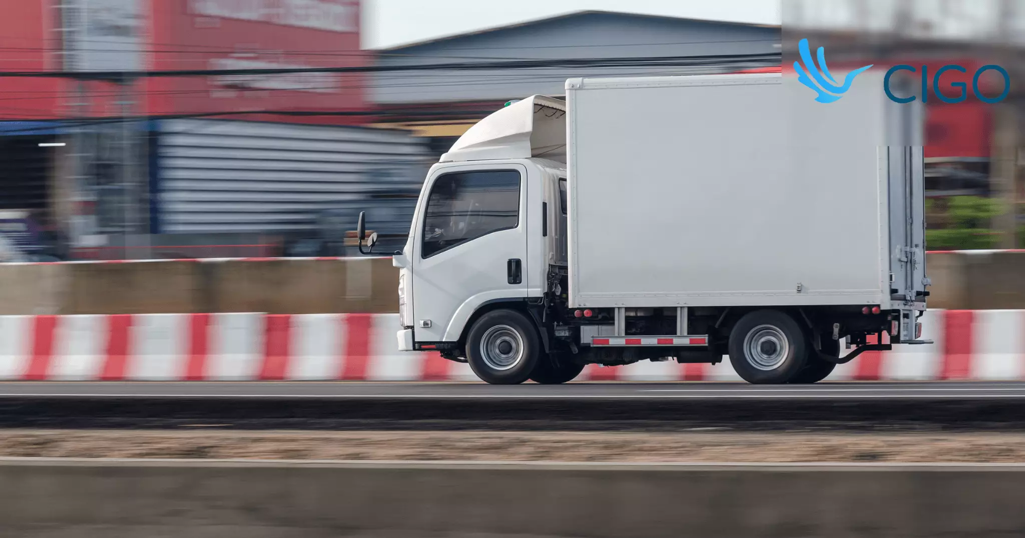 White fleet delivery truck moving through last-mile zone route