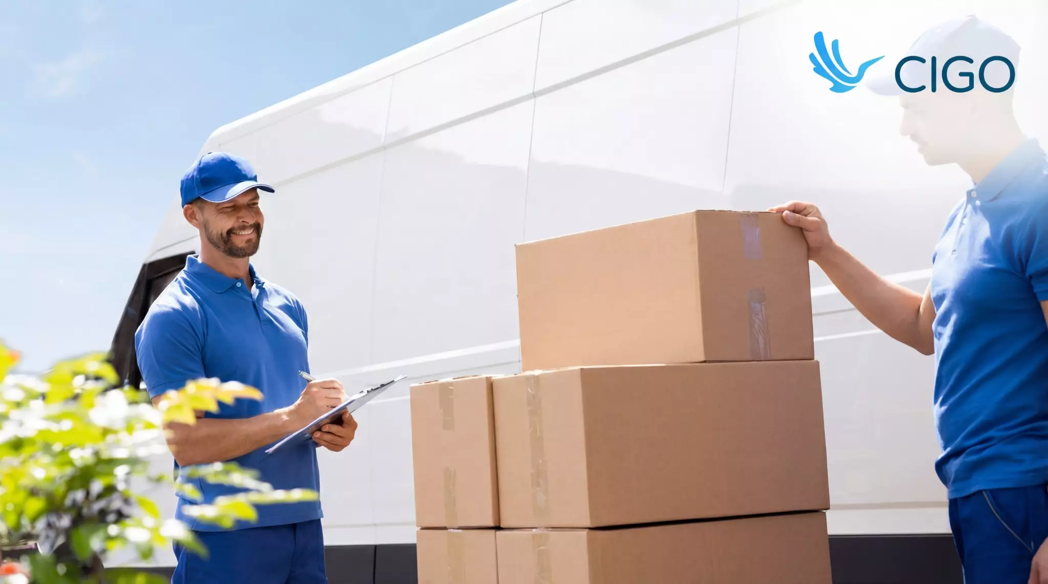 Delivery driver checks quantities on a clipboard beside stacked boxes for clean closeout.
