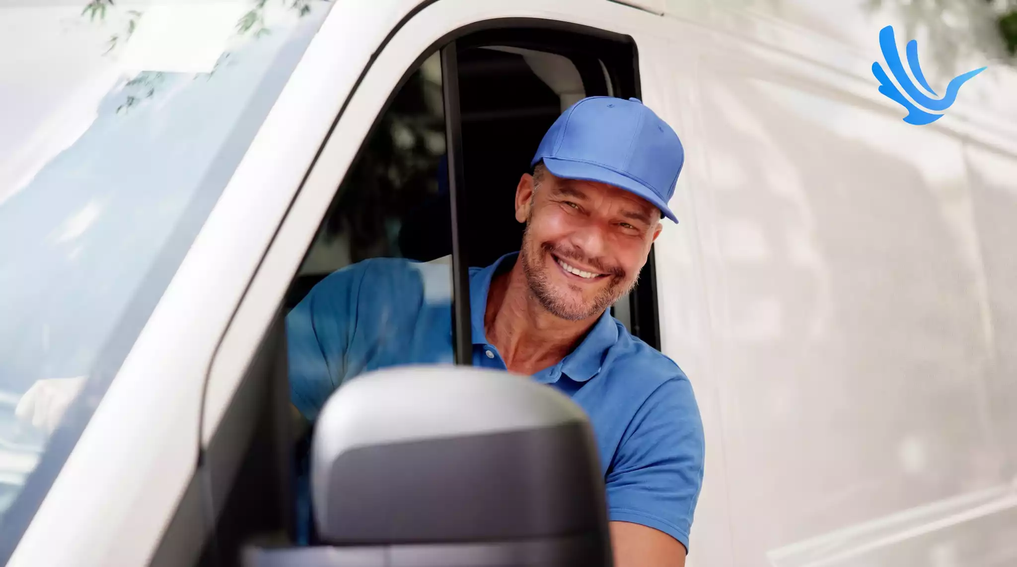 Delivery driver smiling from inside white van window