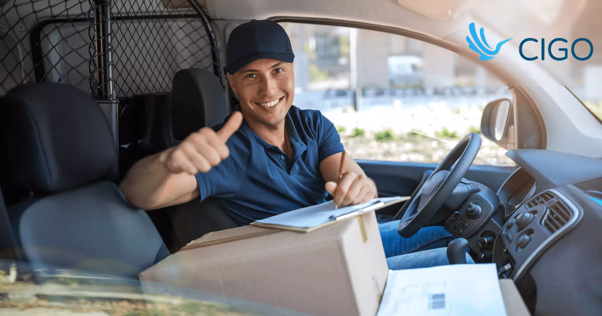 Delivery driver giving thumbs up with package and clipboard in van