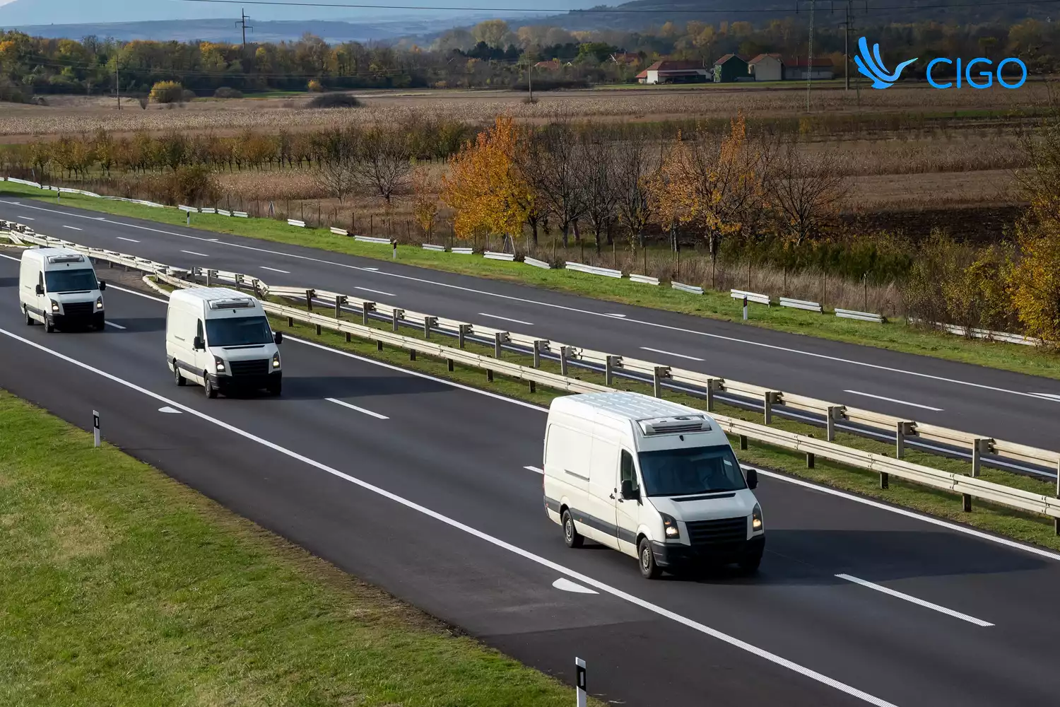 Multiple white fleet delivery vans on capacity-planned highway routes
