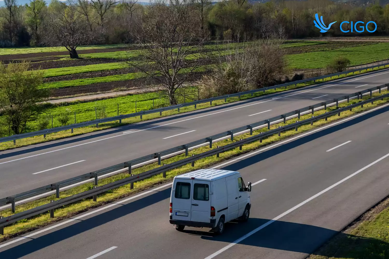 Single white delivery van on open highway route
