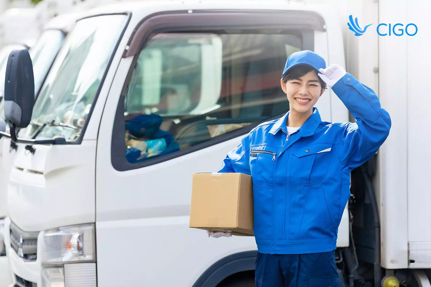 Delivery driver beside a box truck, representing load planning for mattress delivery operations